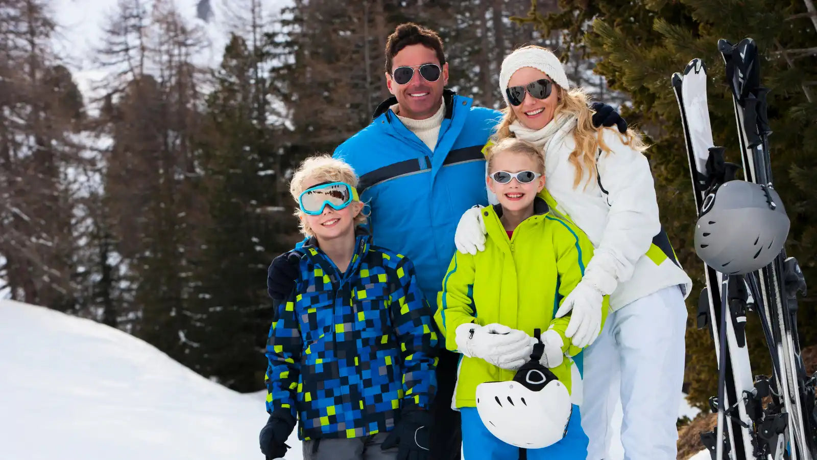 A family of four dressed in ski gear.